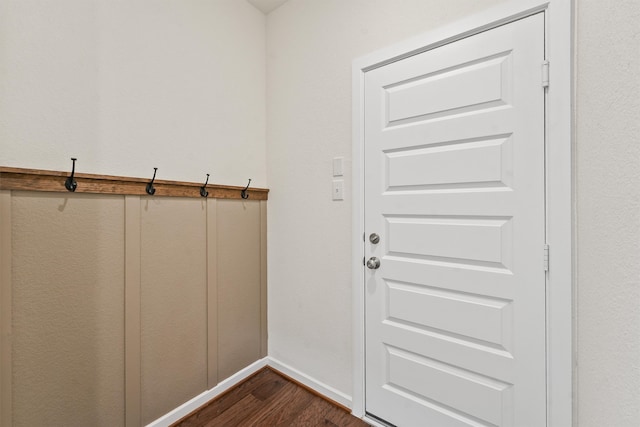 doorway to outside with dark wood-type flooring and baseboards