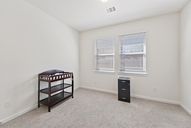 interior space with carpet flooring, visible vents, and baseboards