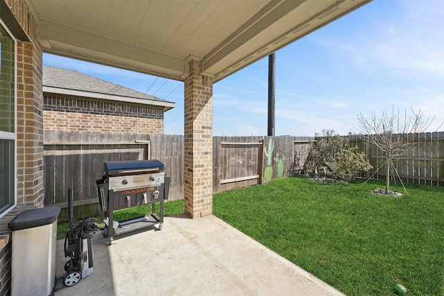 view of patio with a fenced backyard and a grill