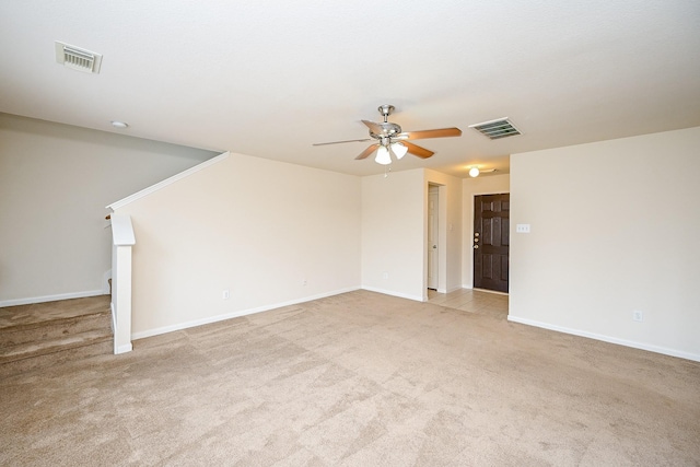 unfurnished room featuring visible vents, ceiling fan, light carpet, and baseboards