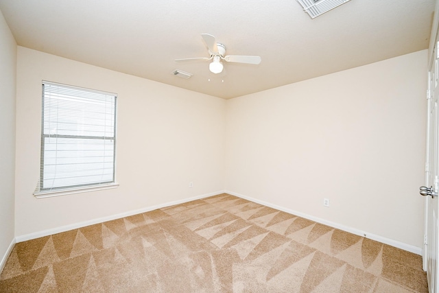 empty room featuring visible vents, light carpet, and baseboards