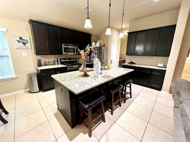 kitchen with stainless steel appliances, light tile patterned flooring, visible vents, and decorative backsplash