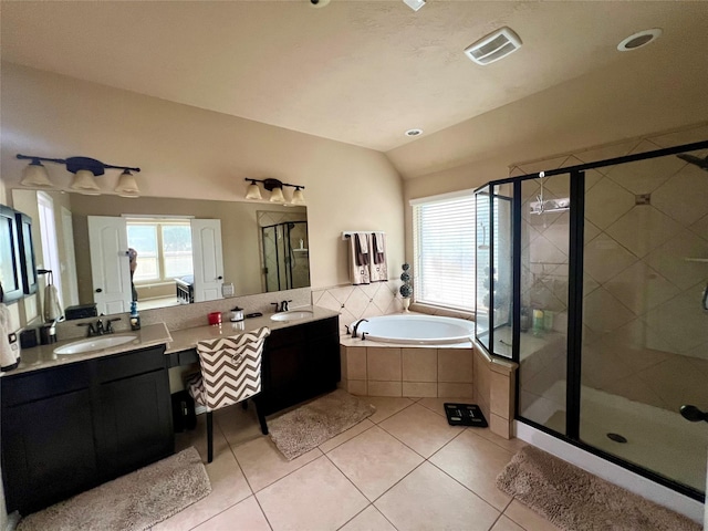 bathroom with a garden tub, a shower stall, visible vents, and a sink