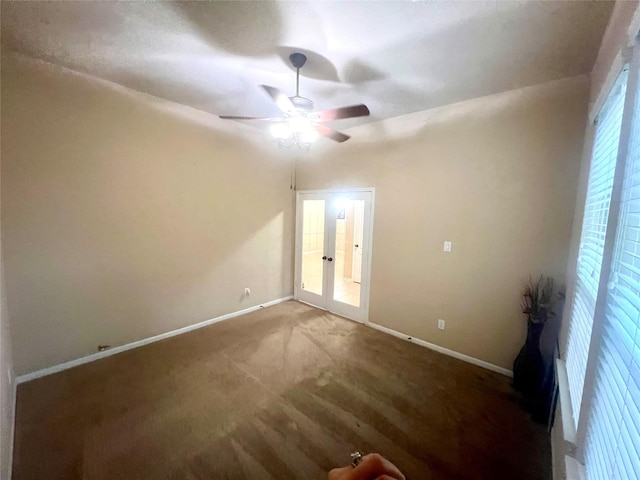 spare room featuring carpet, baseboards, and a ceiling fan