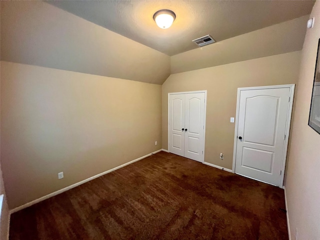 additional living space featuring lofted ceiling, carpet, visible vents, and baseboards