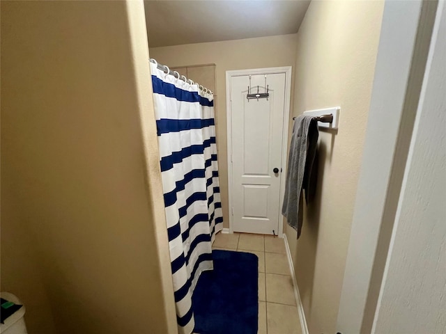 bathroom with tile patterned flooring and a shower with curtain