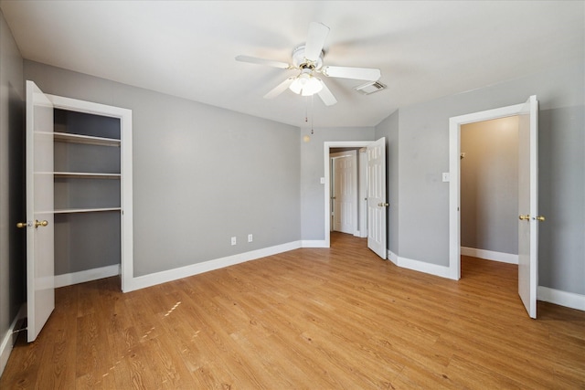 unfurnished bedroom with baseboards, ceiling fan, visible vents, and light wood-style floors