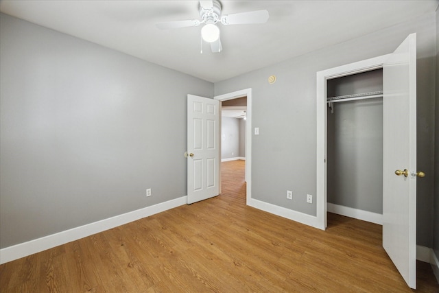 unfurnished bedroom with light wood finished floors, a ceiling fan, baseboards, and a closet