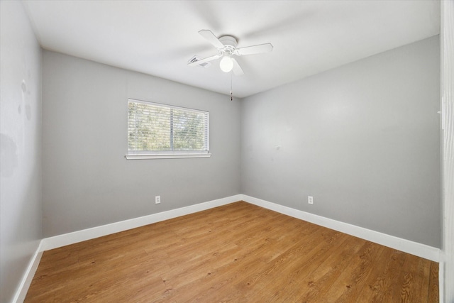 spare room with light wood-type flooring and baseboards