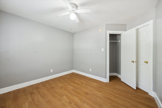 unfurnished bedroom with a closet, light wood-style flooring, and baseboards