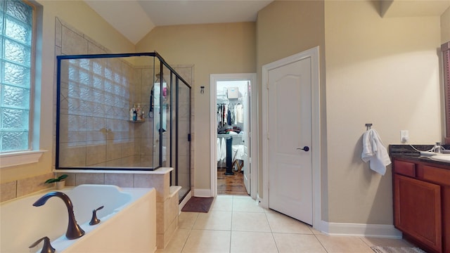 full bathroom featuring tile patterned flooring, vaulted ceiling, vanity, a shower stall, and a bath