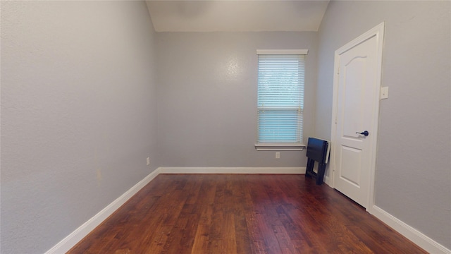 unfurnished room with baseboards and wood finished floors