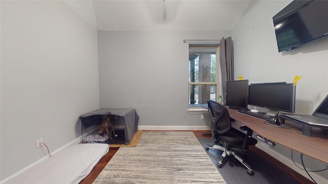 office area featuring baseboards and dark wood-type flooring