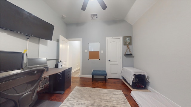 office space featuring ceiling fan, lofted ceiling, dark wood-style flooring, visible vents, and baseboards