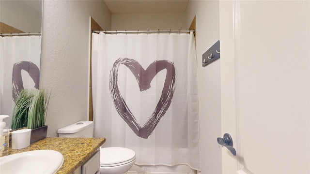 full bath with a shower with shower curtain, a textured wall, vanity, and toilet