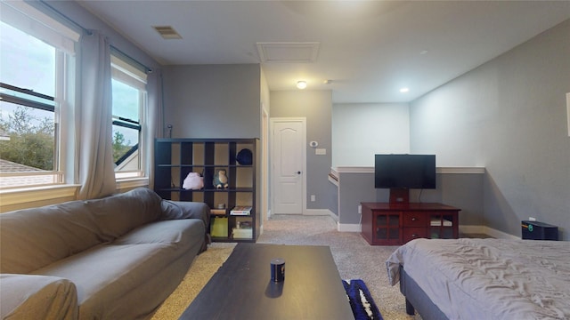 bedroom featuring attic access, carpet, visible vents, and baseboards