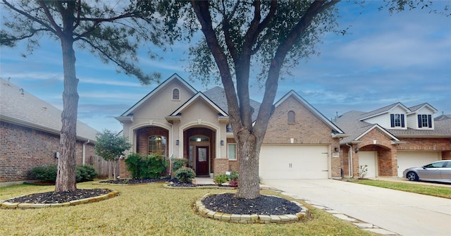 view of front of home featuring a garage, concrete driveway, brick siding, and a front lawn