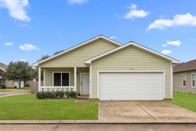 view of front of house with a garage, concrete driveway, a porch, and a front yard