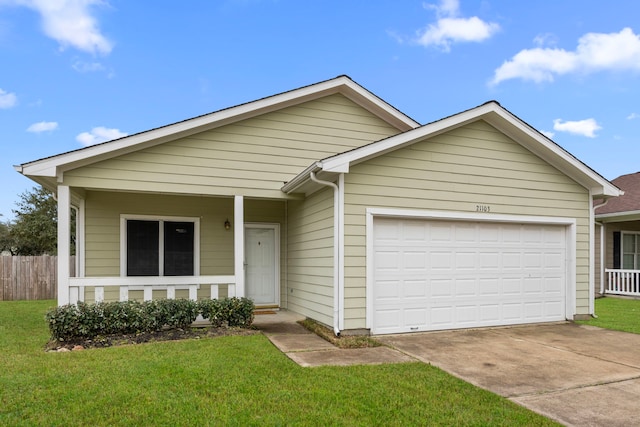 ranch-style house featuring a garage, covered porch, fence, and a front yard