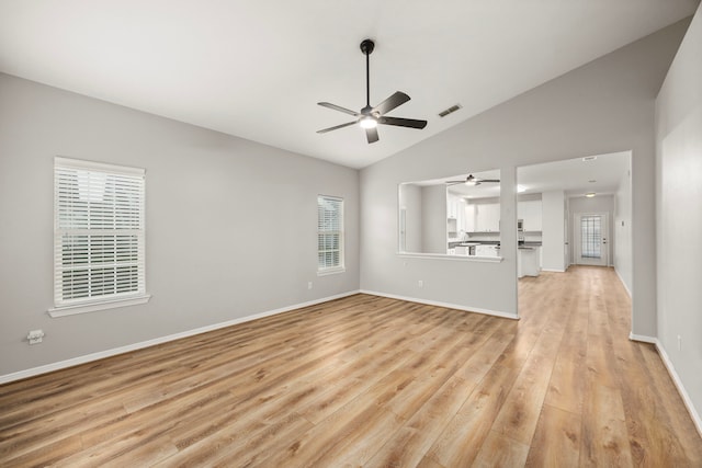 unfurnished living room with lofted ceiling, a ceiling fan, baseboards, visible vents, and light wood-style floors