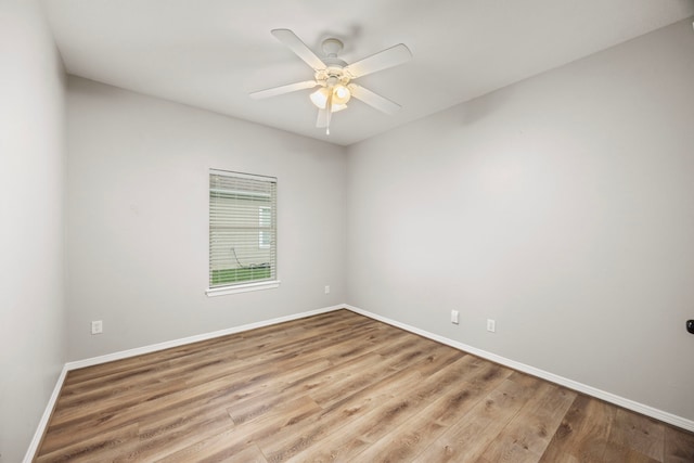 empty room with baseboards, a ceiling fan, and wood finished floors