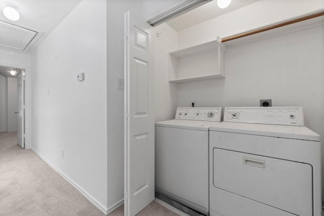 laundry room featuring light colored carpet, laundry area, baseboards, washer and dryer, and attic access