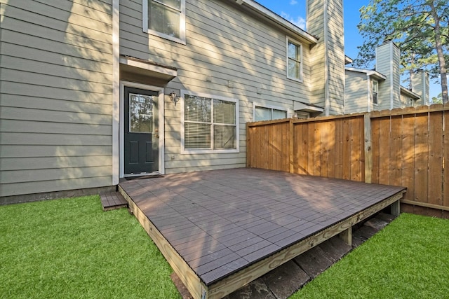 deck featuring fence and a lawn