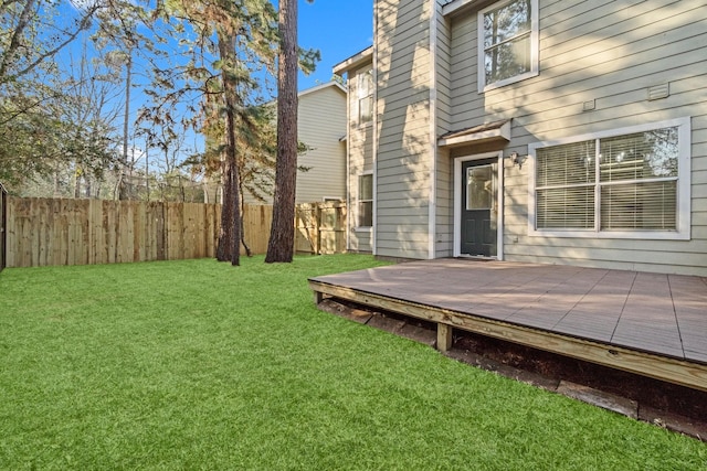 view of yard with fence and a wooden deck