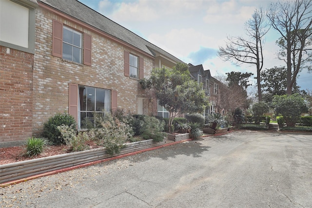 exterior space with brick siding