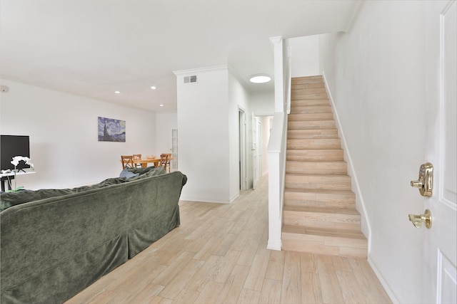 staircase with recessed lighting, wood finished floors, visible vents, and baseboards