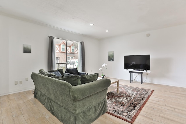 living area featuring baseboards, wood finished floors, and recessed lighting