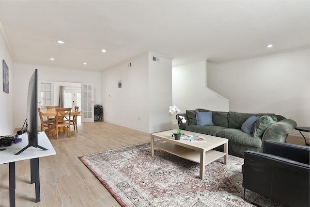 living area featuring french doors, light wood-type flooring, visible vents, and recessed lighting