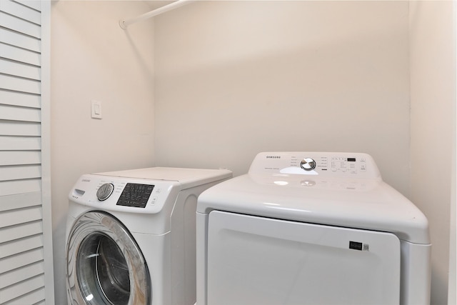 washroom featuring laundry area and washer and clothes dryer