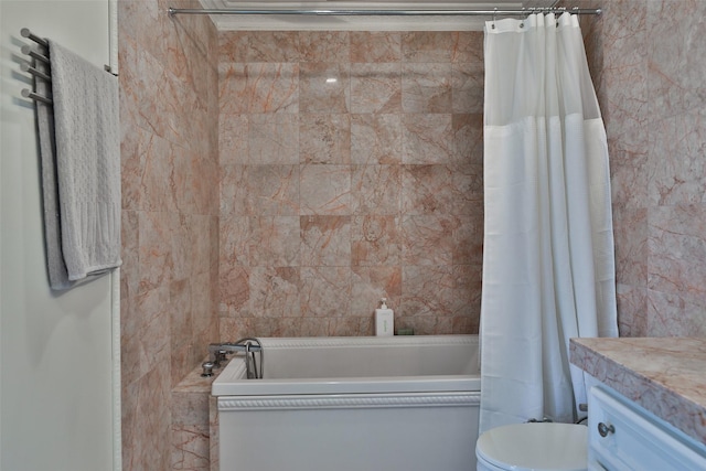 bathroom featuring toilet, shower / bath combo with shower curtain, and vanity