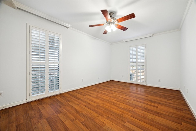 spare room featuring ornamental molding, wood finished floors, a ceiling fan, and baseboards