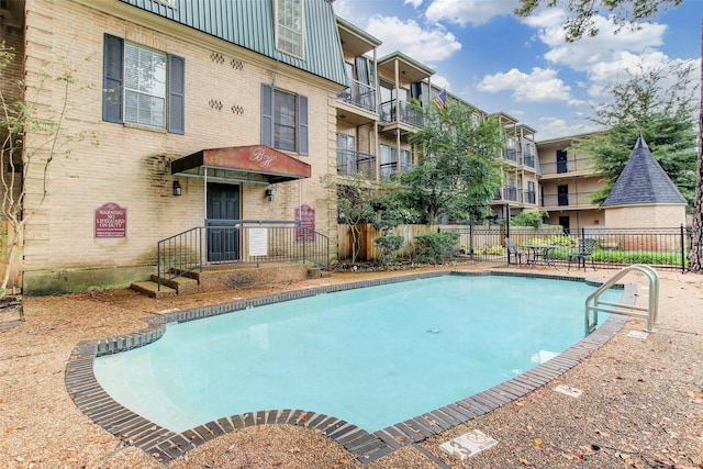 community pool featuring fence