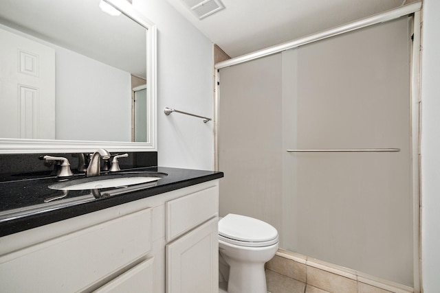 full bathroom featuring a shower with door, visible vents, toilet, vanity, and tile patterned flooring