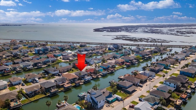 drone / aerial view featuring a residential view and a water view