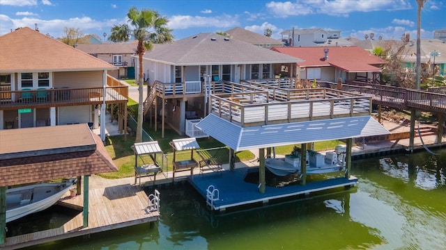 view of dock featuring a water view, boat lift, and a residential view