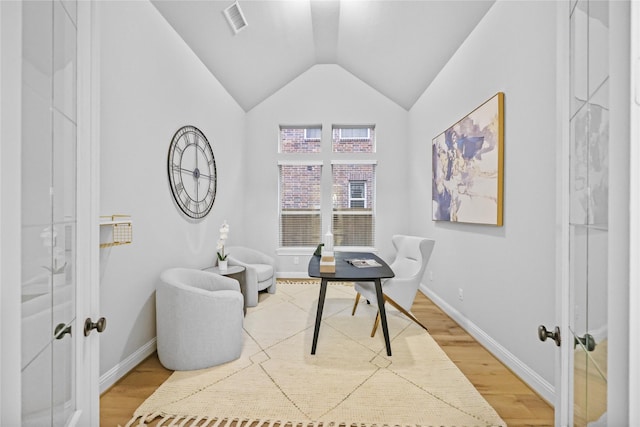 sitting room with lofted ceiling, french doors, baseboards, and light wood finished floors