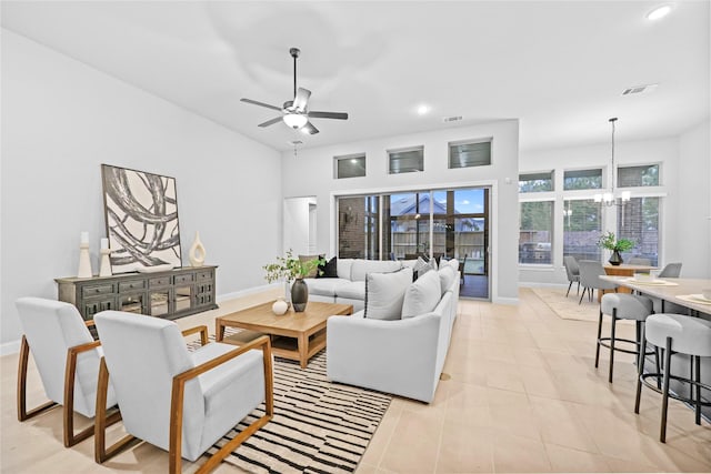 living area featuring light tile patterned floors, visible vents, and baseboards