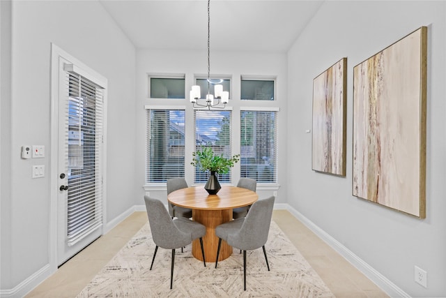 dining space featuring a notable chandelier and baseboards