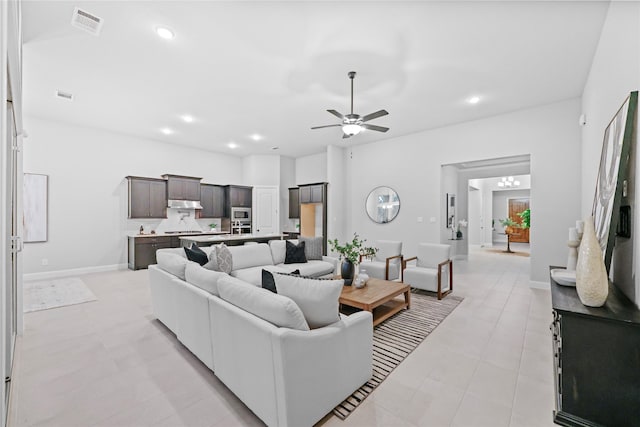 living room with a ceiling fan, visible vents, and recessed lighting