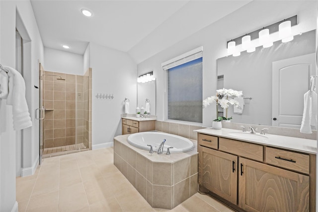 bathroom featuring two vanities, tile patterned floors, a sink, a shower stall, and a bath