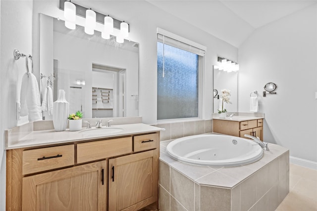 full bathroom with a jetted tub, two vanities, a sink, and lofted ceiling