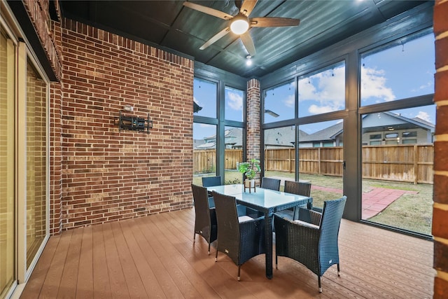 sunroom featuring ceiling fan