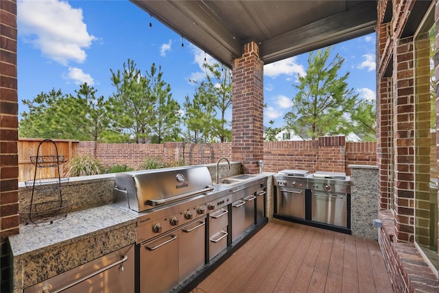 view of patio featuring a sink, area for grilling, and a fenced backyard