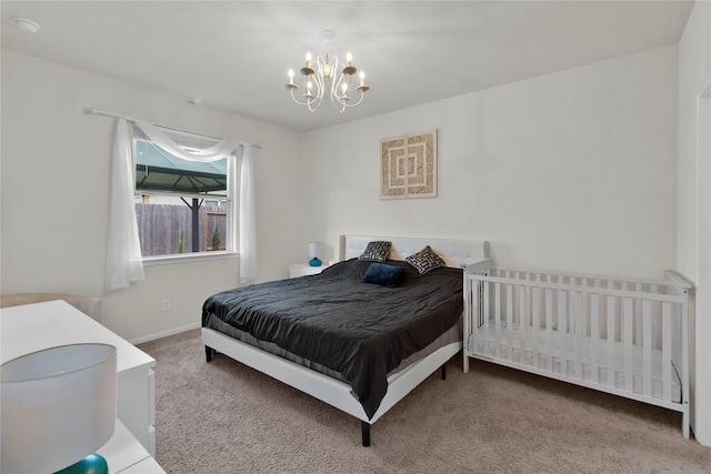 bedroom featuring carpet flooring, baseboards, and an inviting chandelier