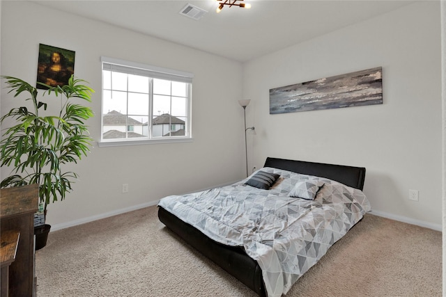 bedroom with carpet, visible vents, and baseboards