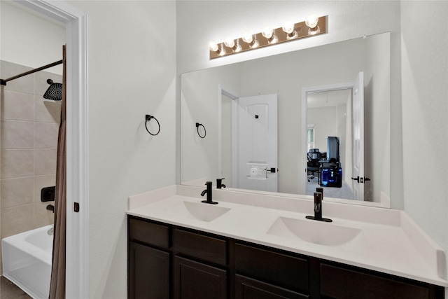 bathroom featuring double vanity, shower / bath combo, and a sink